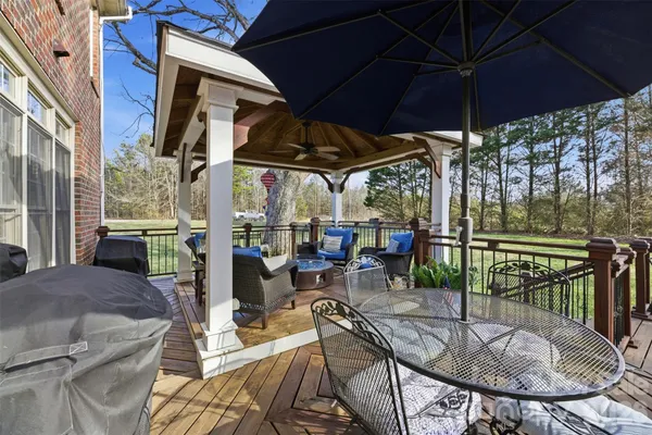 a view of balcony with chairs and umbrella