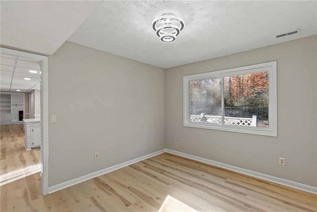 3428 Runelle Place Southwest Lilburn, GA 30047 - Photo 13 of 36 a view of empty room with window and wooden floor