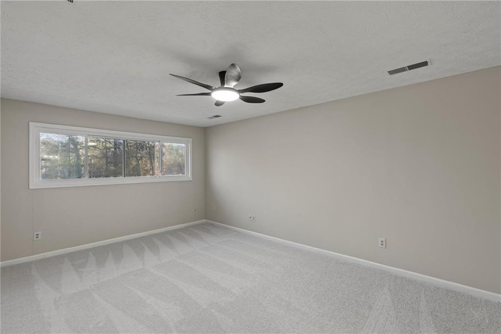 3428 Runelle Place Southwest Lilburn, GA 30047 - Photo 19 of 36 an empty room with a window