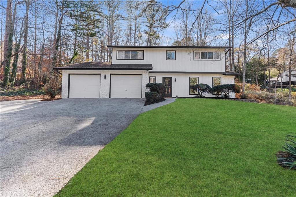 3428 Runelle Place Southwest Lilburn, GA 30047 - Photo 2 of 36 a view of a house with a back yard