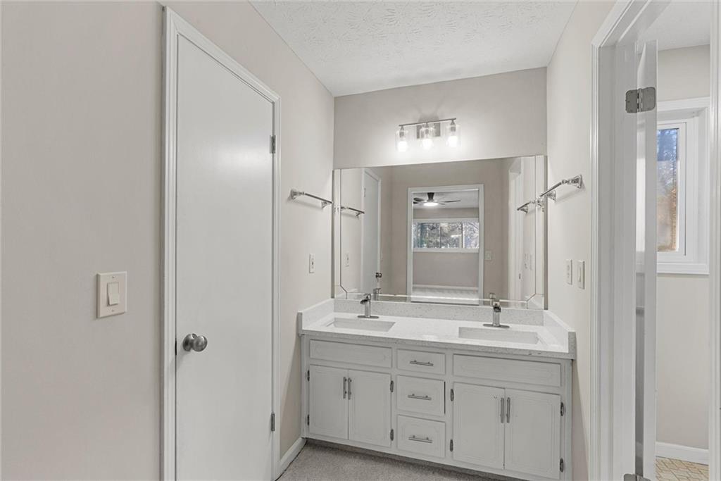 3428 Runelle Place Southwest Lilburn, GA 30047 - Photo 21 of 36 a bathroom with double vanity sink and a mirror