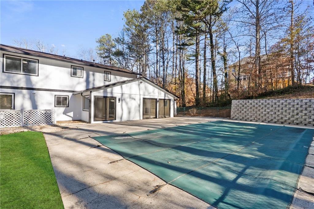 3428 Runelle Place Southwest Lilburn, GA 30047 - Photo 31 of 36 a front view of a house with a yard