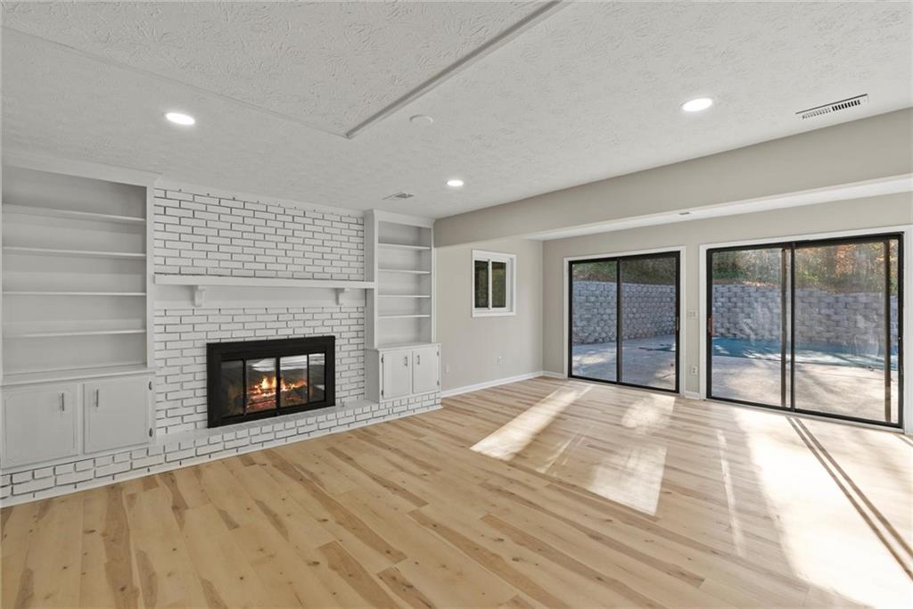 3428 Runelle Place Southwest Lilburn, GA 30047 - Photo 4 of 36 a view of an empty room with a fireplace and a window