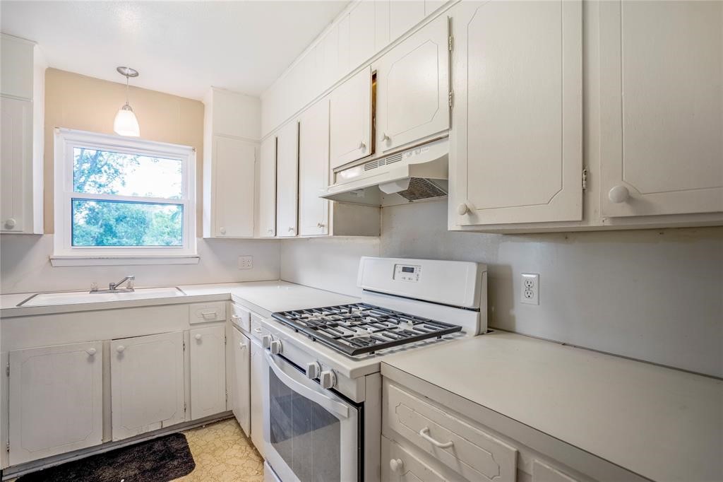 3532 Midwest Drive, Unit B Bryan, TX 77802 - Photo 14 of 21 a kitchen with white cabinets and appliances
