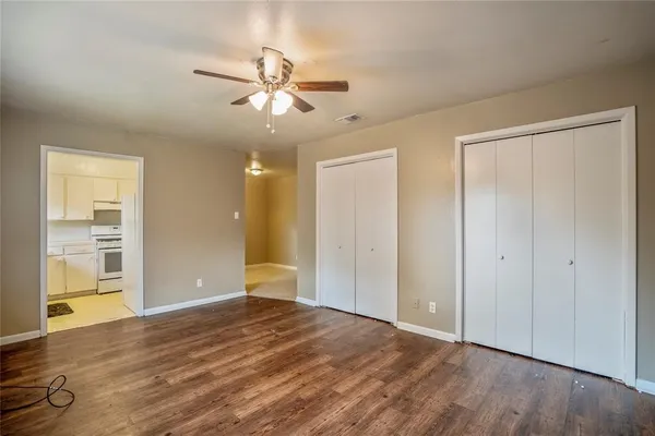 a view of an empty room with wooden floor