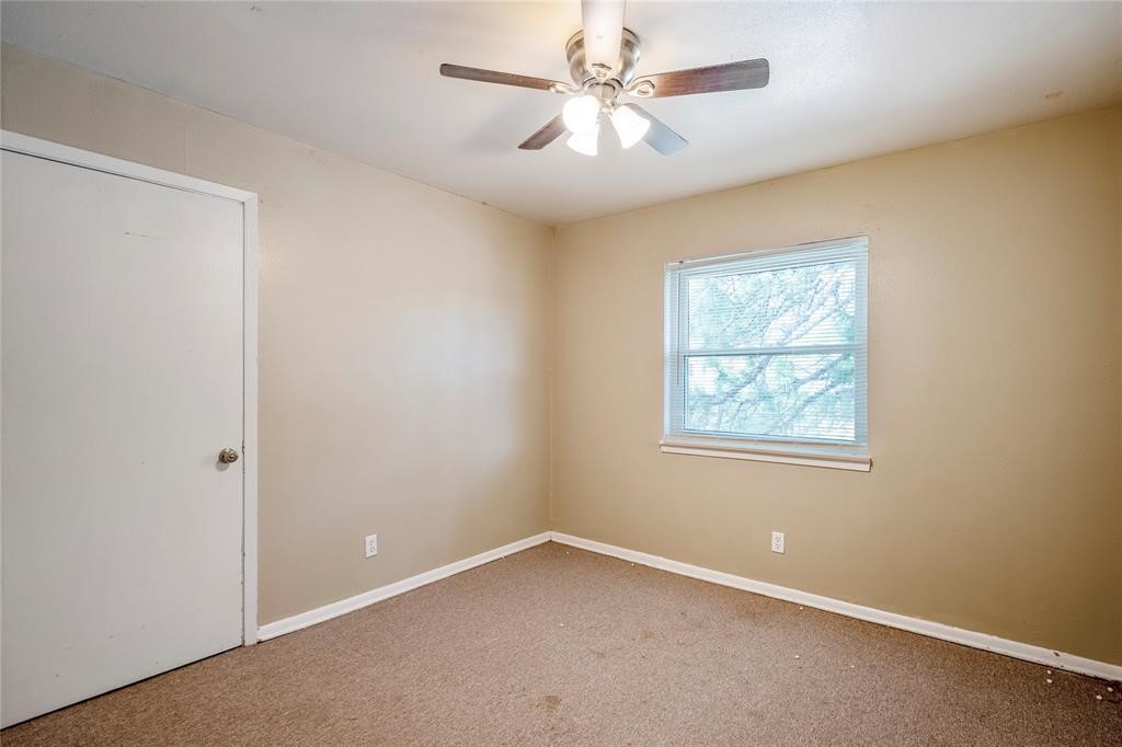 3532 Midwest Drive, Unit B Bryan, TX 77802 - Photo 3 of 21 an empty room with a window and a fan