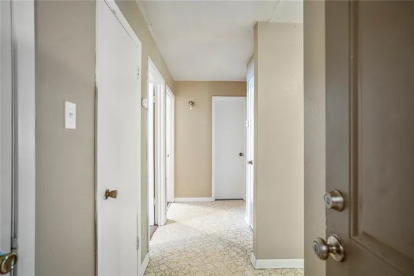 a view of a room with a door and mirror