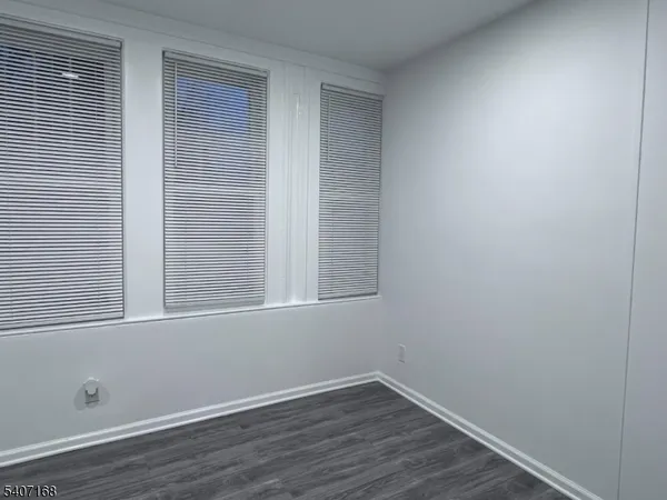 a view of a small space with wooden floor and a window