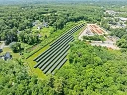 an aerial view of a garden with a swimming pool