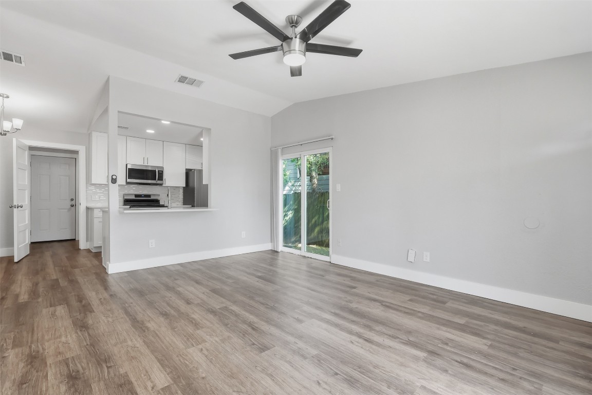 5106 Nuckols Crossing Road, Unit B Austin, TX 78744 - Photo 2 of 8 a view of a kitchen with a ceiling fan hardwood floor and a kitchen