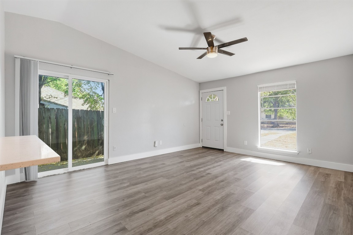 5106 Nuckols Crossing Road, Unit B Austin, TX 78744 - Photo 3 of 8 a view of an empty room with wooden floor and a window