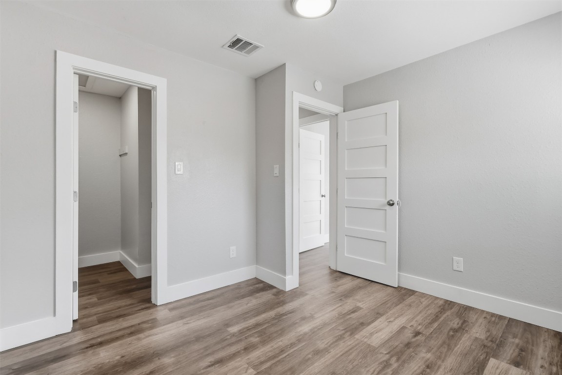 5106 Nuckols Crossing Road, Unit B Austin, TX 78744 - Photo 5 of 8 a view of empty room with wooden floor