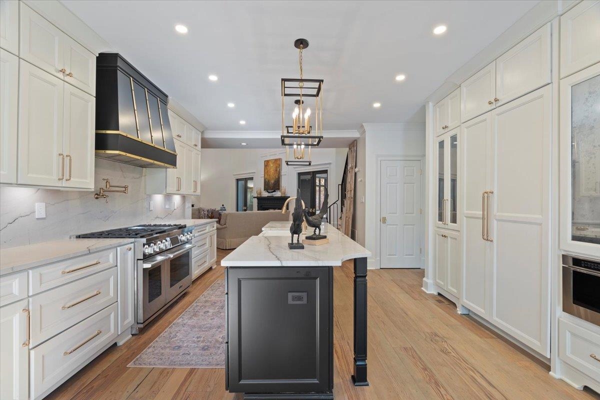 425 River Oaks Road Memphis, TN 38120 - Photo 12 of 39 a kitchen with kitchen island white cabinets and stainless steel appliances