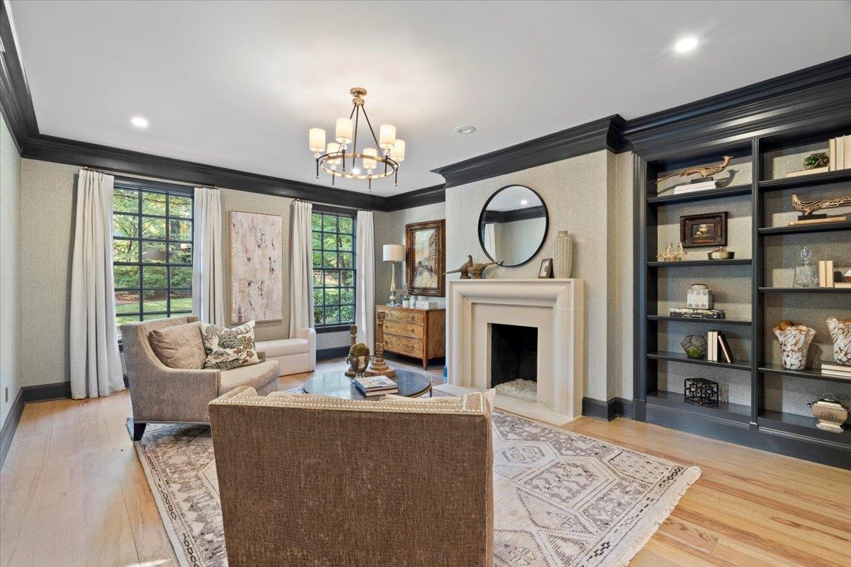 425 River Oaks Road Memphis, TN 38120 - Photo 15 of 39 a living room with furniture a fireplace and a chandelier
