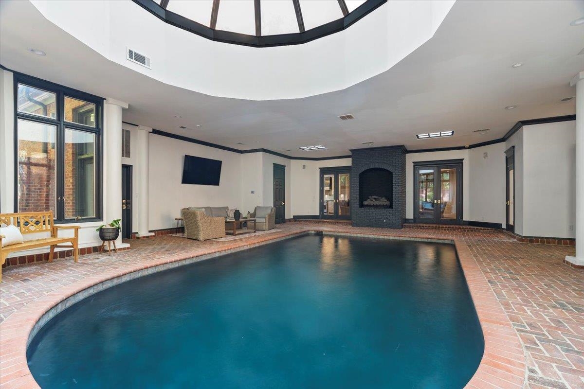 425 River Oaks Road Memphis, TN 38120 - Photo 26 of 39 a view of swimming pool with a table and chairs