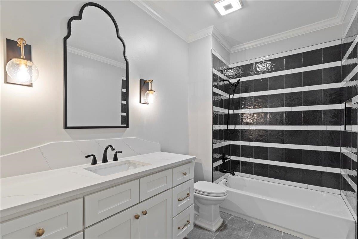 425 River Oaks Road Memphis, TN 38120 - Photo 33 of 39 a bathroom with a sink a toilet and a mirror