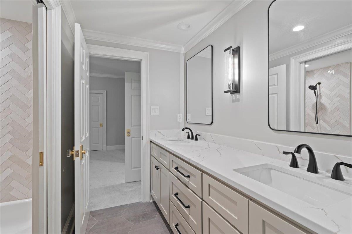 425 River Oaks Road Memphis, TN 38120 - Photo 34 of 39 a bathroom with double vanity sinks and a mirror