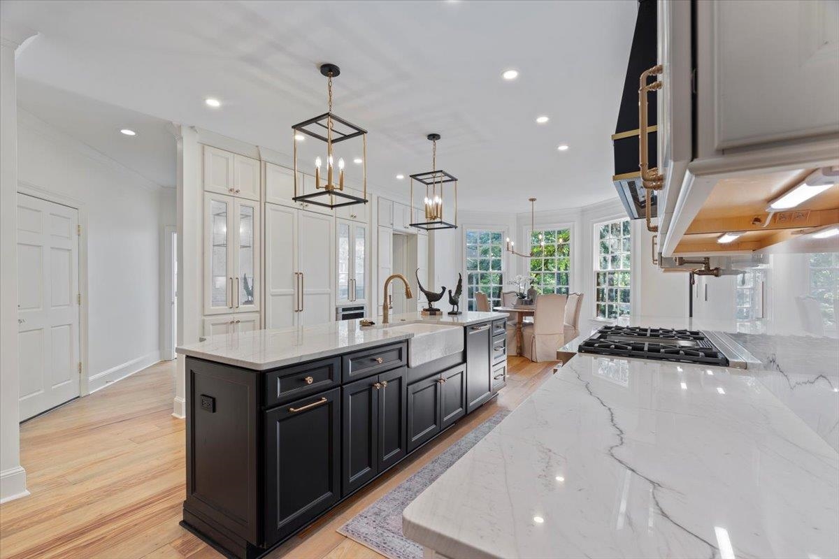 425 River Oaks Road Memphis, TN 38120 - Photo 9 of 39 a kitchen with stainless steel appliances granite countertop a sink a stove and a wooden floors