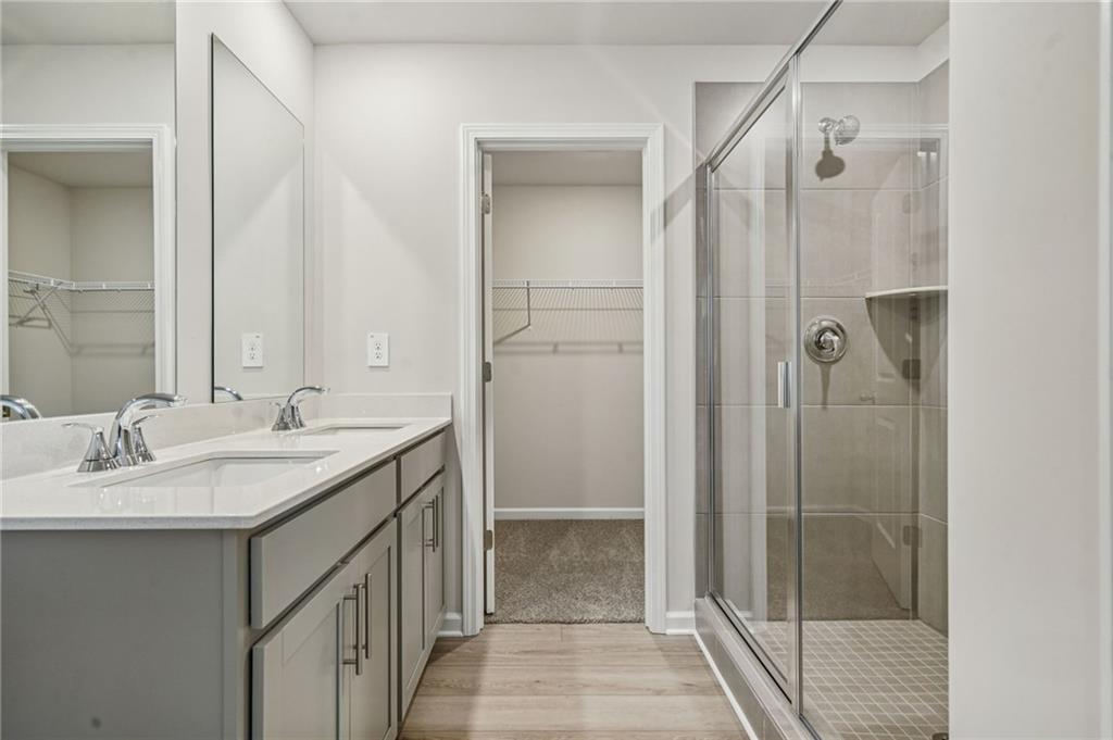 2004 Nolan Way Conyers, GA 30013 - Photo 18 of 23 a bathroom with a granite countertop sink shower and a mirror