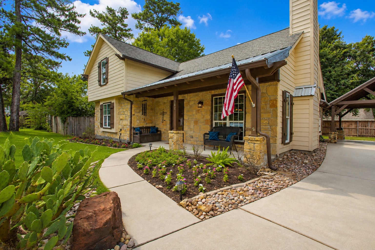 312 Springwood Drive Conroe, TX 77385 - Photo 6 of 50 Inviting covered front porch offers the perfect place to relax and enjoy the peaceful surroundings.