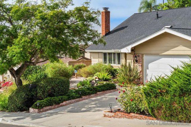 a view of a house with a yard and plants