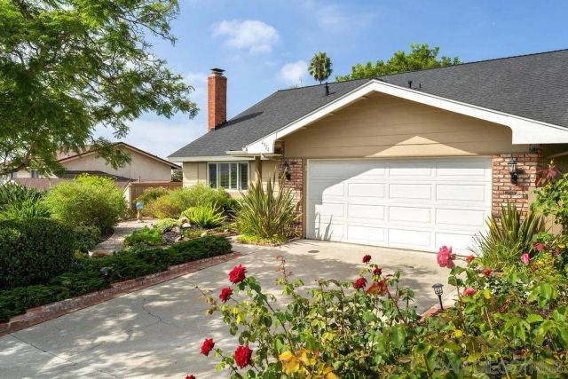 a house with flowers in front of it