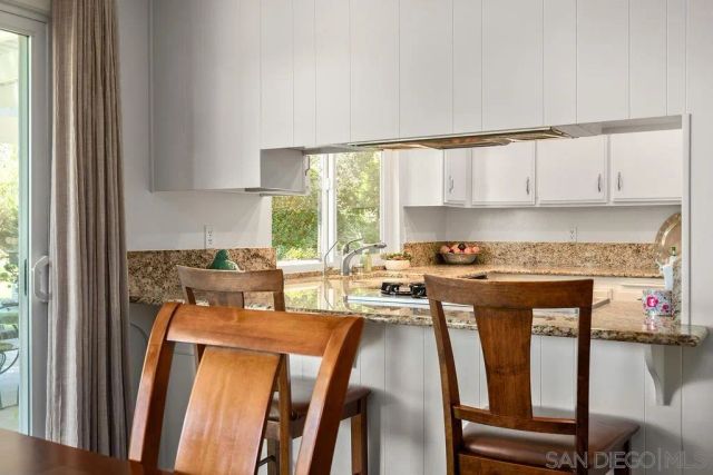 a view of a patio with table and chairs and potted plants