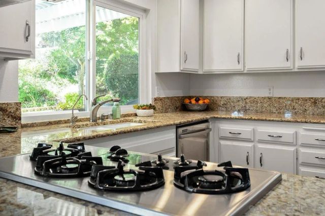 a view of a patio with a table chairs and a backyard