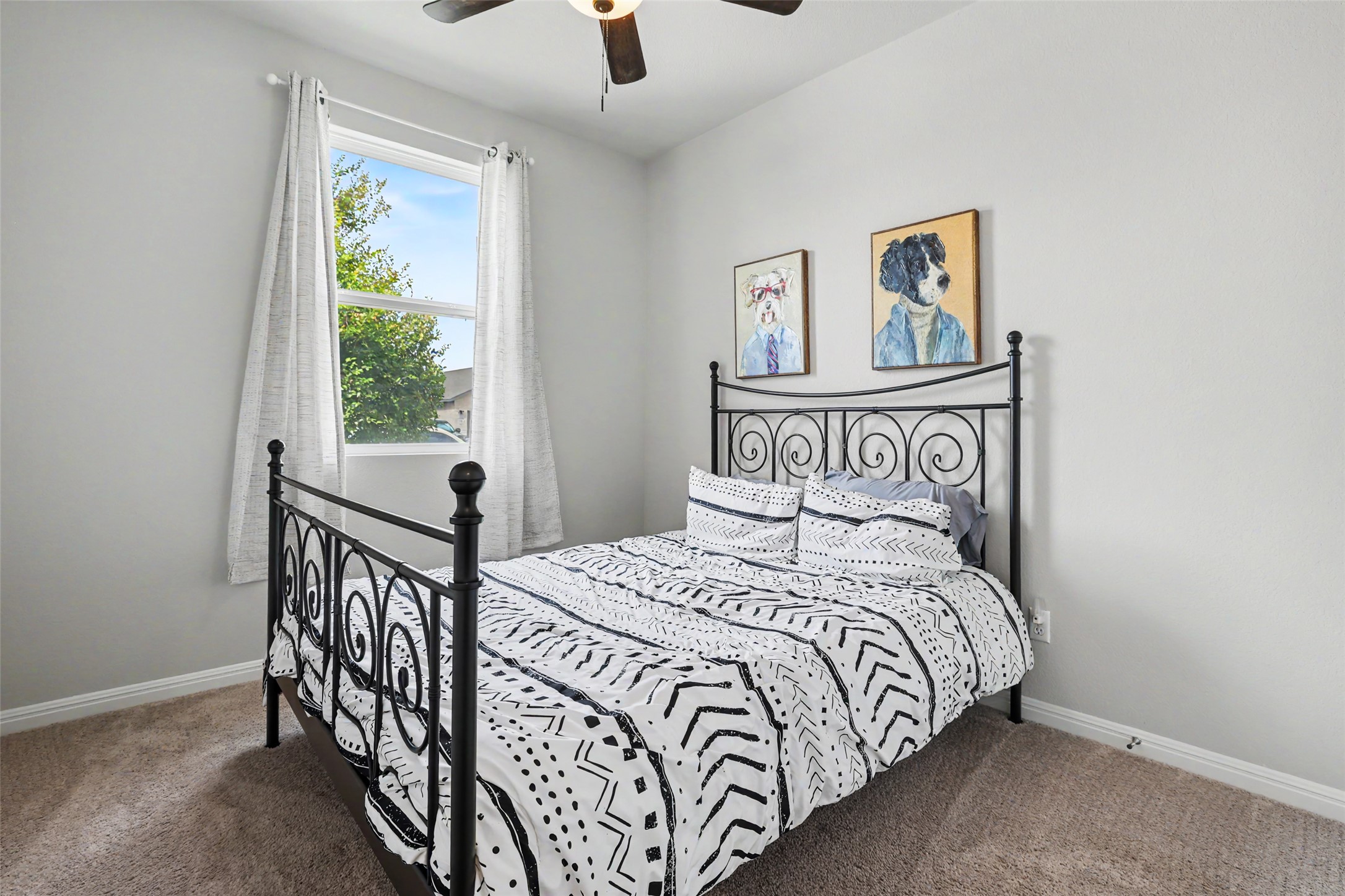 112 Rocking R Court Georgetown, TX 78633 - Photo 28 of 40 A window-filled bedroom with soft, inviting carpet offers a tranquil retreat.