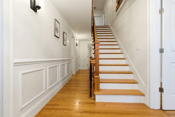 a view of entryway and hall with wooden floor