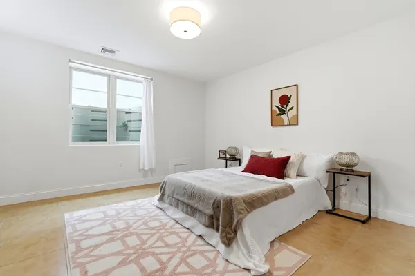 a bedroom with a bed and a window