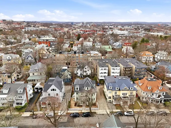 an aerial view of residential houses with city view