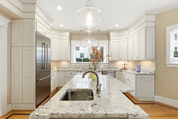 a kitchen with stainless steel appliances granite countertop a refrigerator sink and cabinets