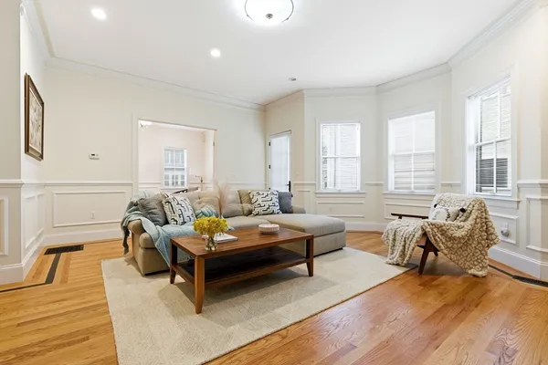 a living room with furniture and wooden floor