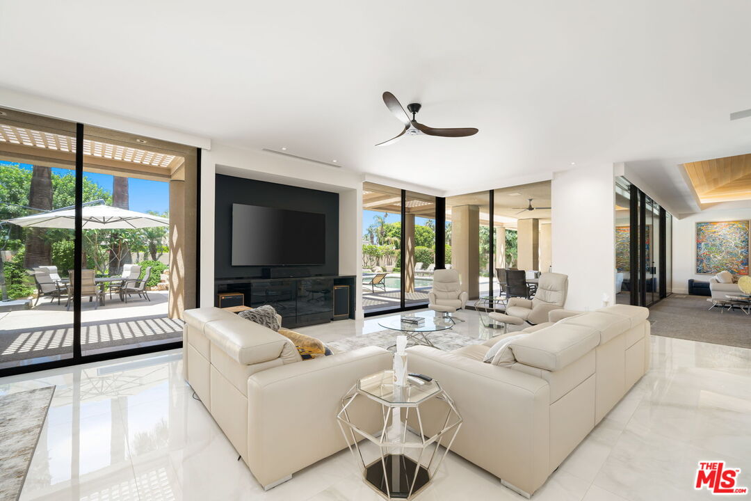 40590 Morningstar Road Rancho Mirage, CA 92270 - Photo 12 of 39 a living room with furniture a flat screen tv and a large window