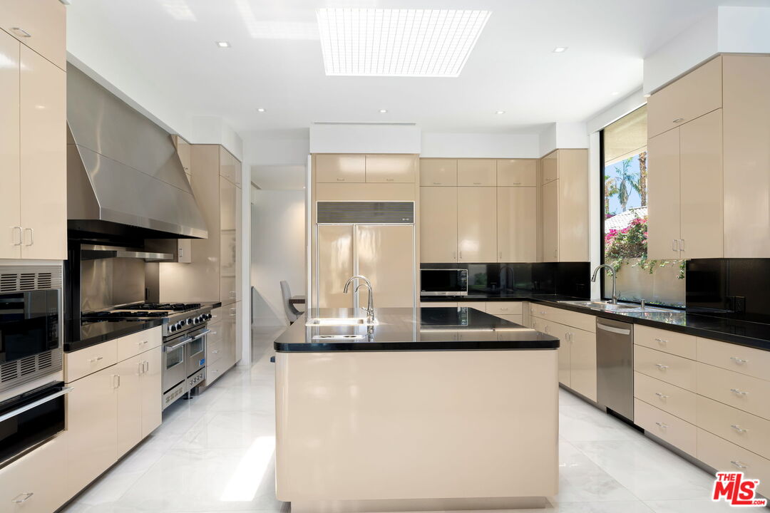 40590 Morningstar Road Rancho Mirage, CA 92270 - Photo 14 of 39 a kitchen with stainless steel appliances a sink stove and microwave