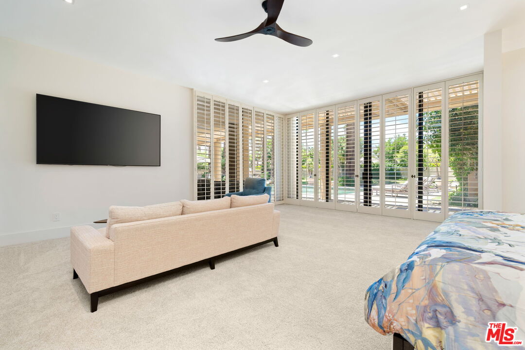 40590 Morningstar Road Rancho Mirage, CA 92270 - Photo 25 of 39 a living room with furniture and a flat screen tv