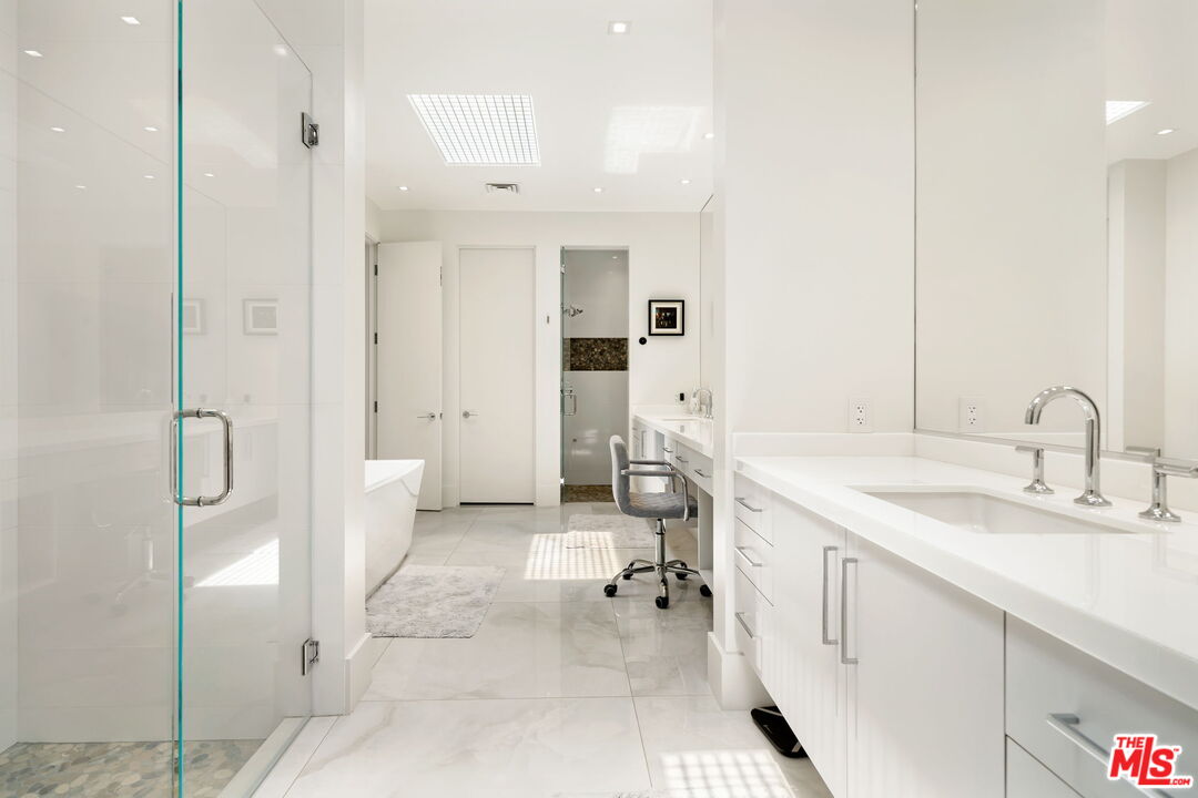 40590 Morningstar Road Rancho Mirage, CA 92270 - Photo 27 of 39 a spacious bathroom with a granite countertop sink mirror and shower