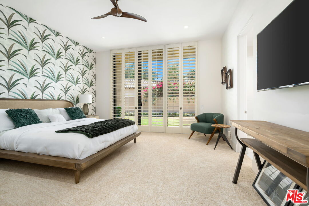 40590 Morningstar Road Rancho Mirage, CA 92270 - Photo 30 of 39 a living room with furniture and a flat screen tv