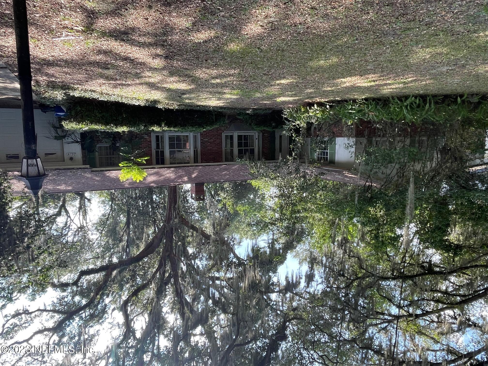 2614 Red Fox Road Orange Park, FL 32073 - Photo 1 of 7 a front view of a house with a yard and potted plants