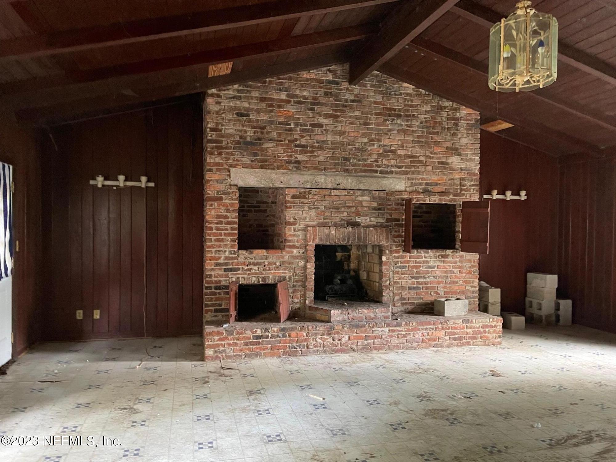 2614 Red Fox Road Orange Park, FL 32073 - Photo 4 of 7 a view of empty room with fireplace and wooden floor