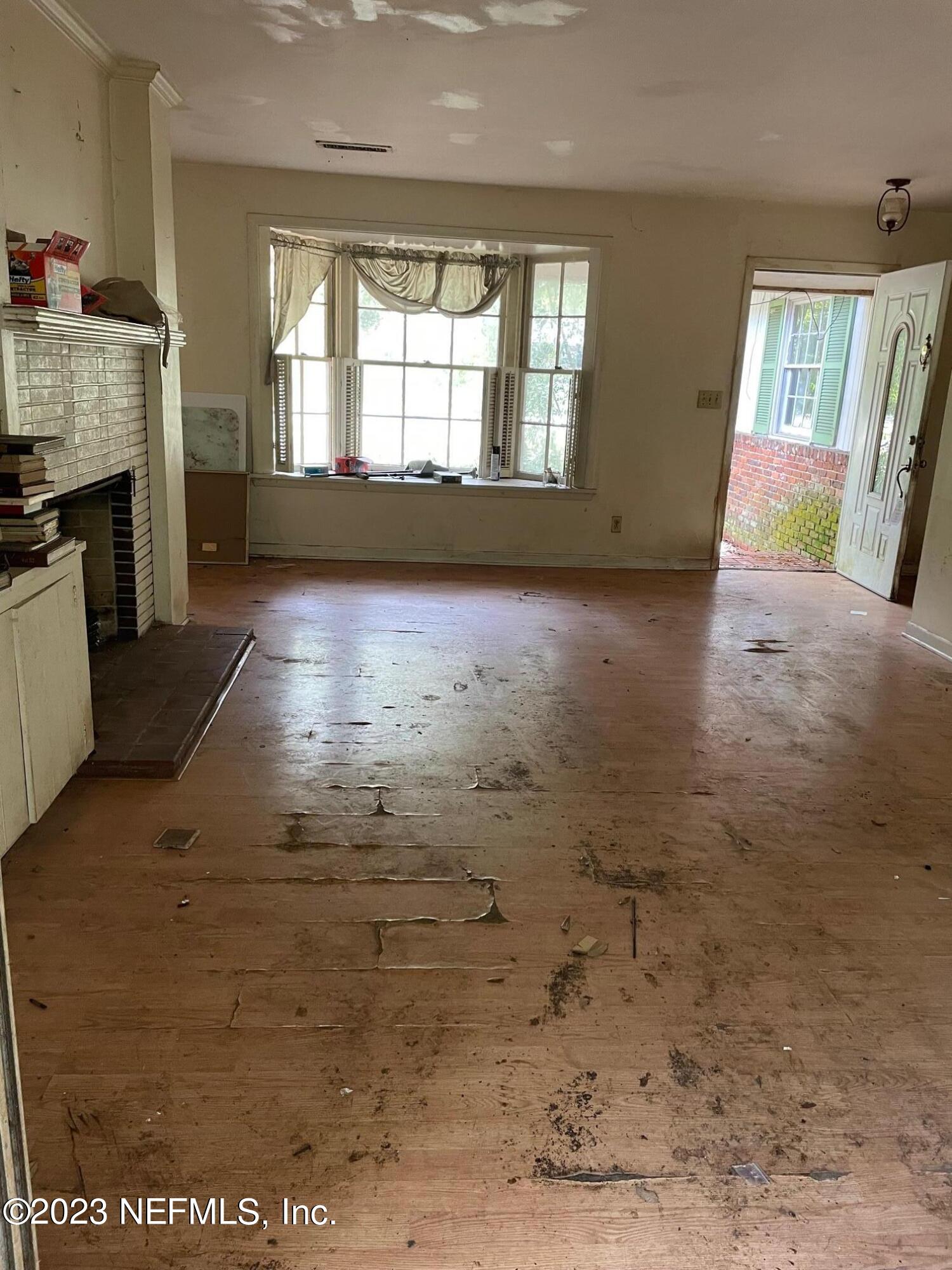 2614 Red Fox Road Orange Park, FL 32073 - Photo 6 of 7 wooden floor in an empty room with a fireplace