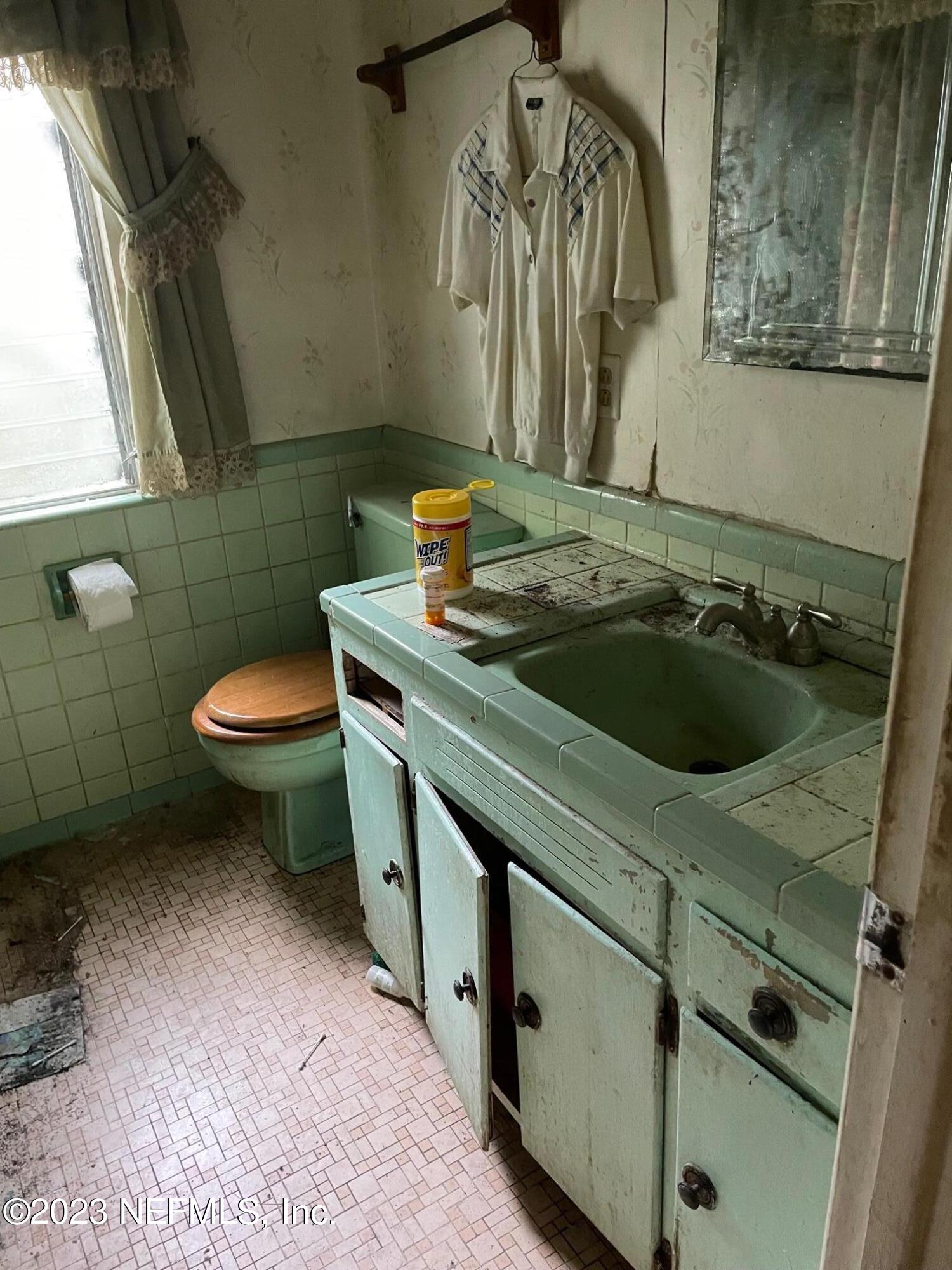 2614 Red Fox Road Orange Park, FL 32073 - Photo 7 of 7 a bathroom with a sink a toilet and mirror