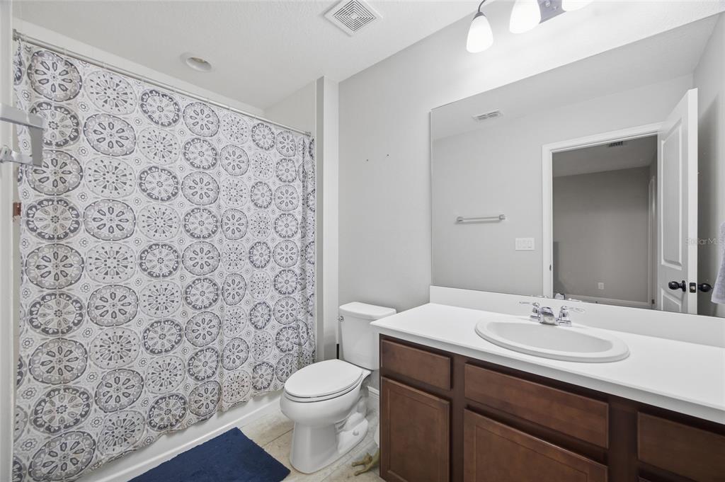 2013 Sunset Wind Loop Oldsmar, FL 34677 - Photo 27 of 43 a bathroom with a sink toilet and shower