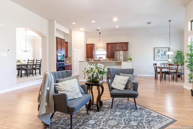 a living room with furniture and wooden floor