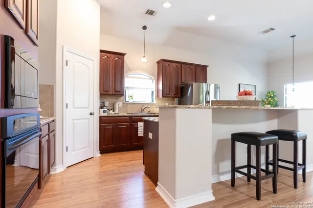 a kitchen with stainless steel appliances a sink and a refrigerator