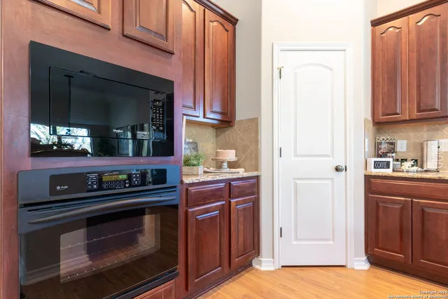 a kitchen with stainless steel appliances granite countertop a stove and a microwave