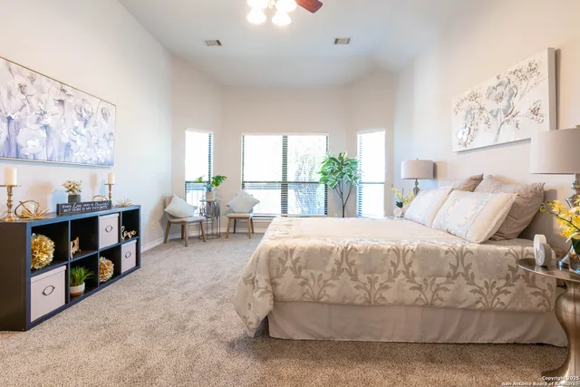 a spacious bedroom with a bed and a large window