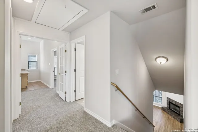 an empty room with a window and a fan