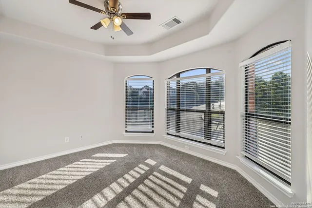 a view of a room with a window and ceiling fan